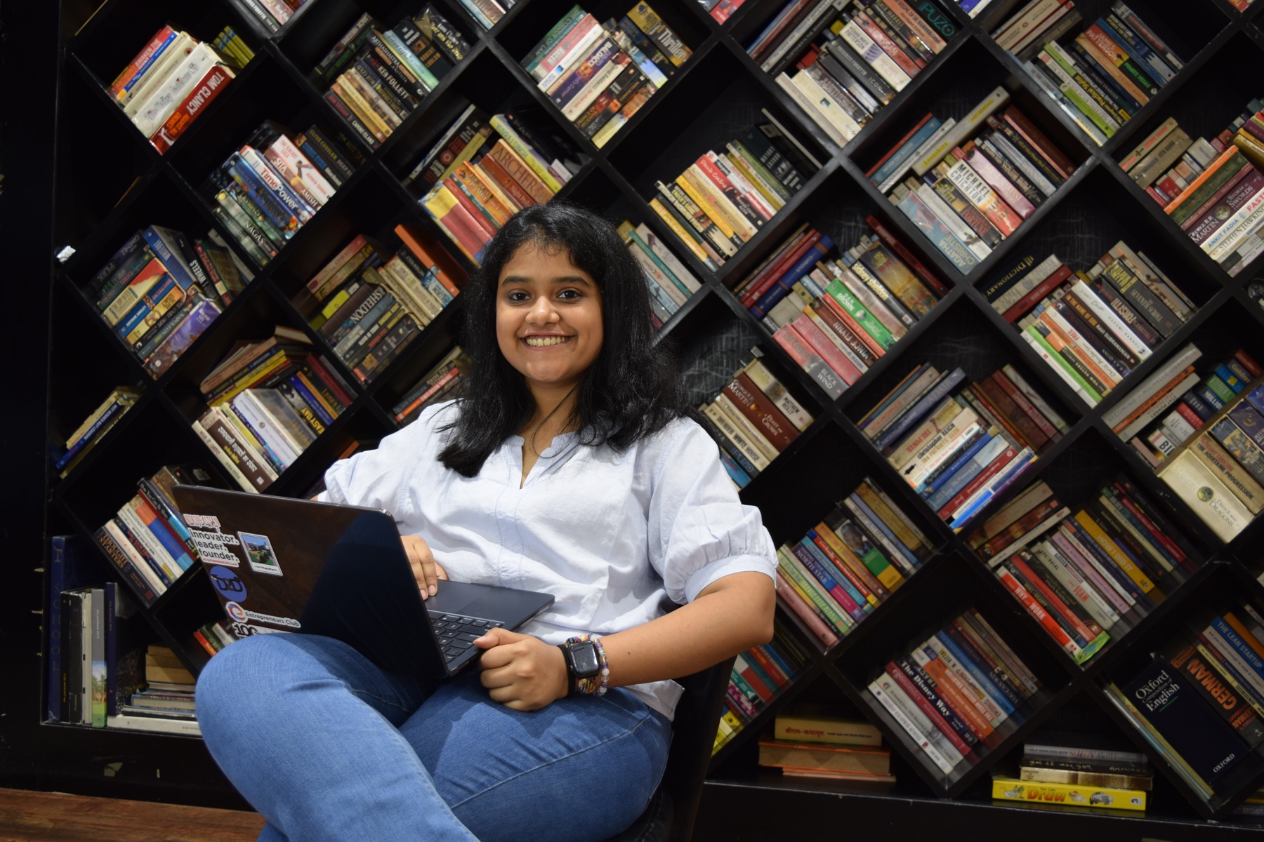 Anjali Laddha with her laptop in a library
